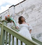 Lindsay with bouquet on stairs